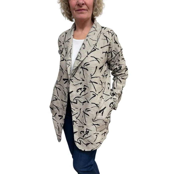 Woman wearing a patterned beige cardigan on a white background