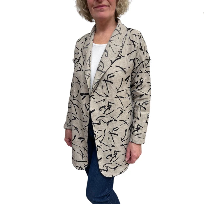 Person wearing a patterned beige jacket on a white background