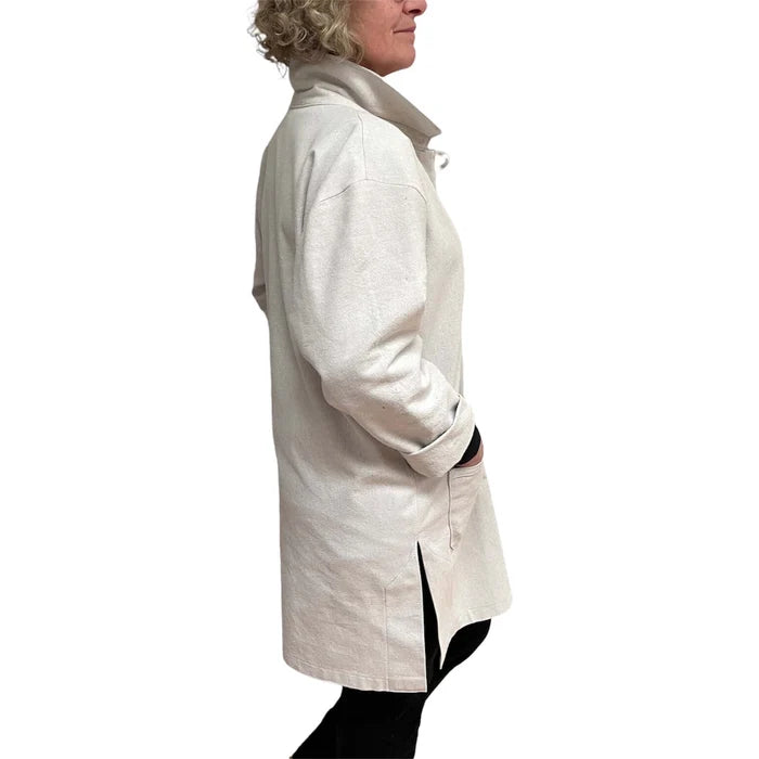 Person wearing a white coat on a white background
