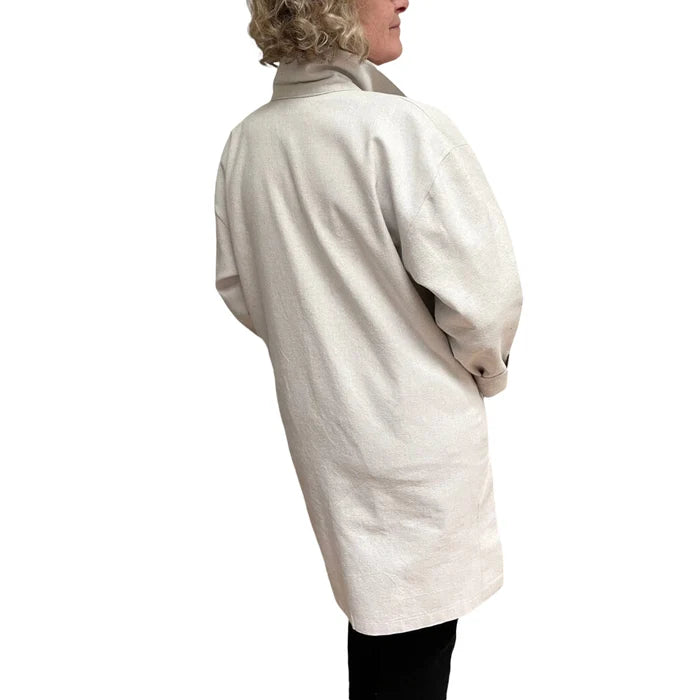 Person wearing a beige coat on a white background