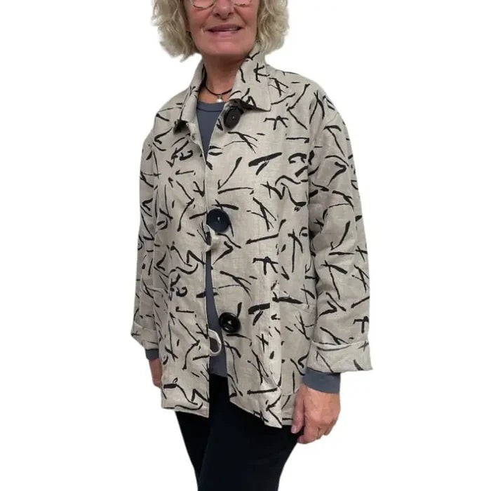 Person wearing a patterned beige jacket on a white background