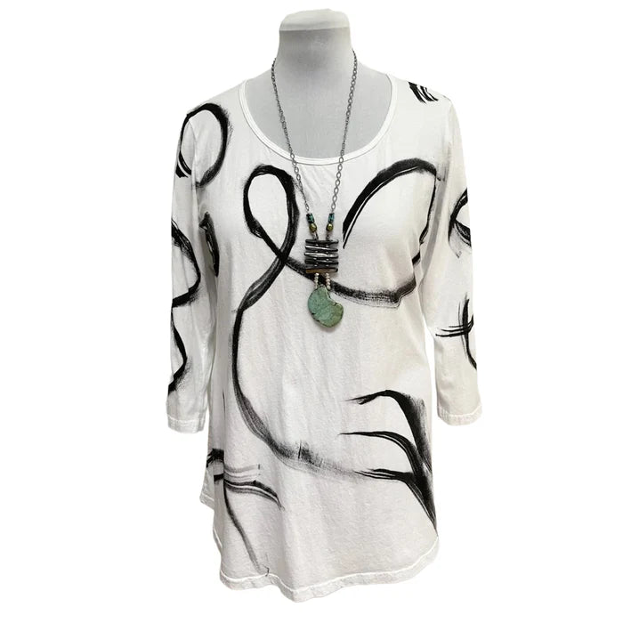 White dress with black abstract patterns on a mannequin against a white background
