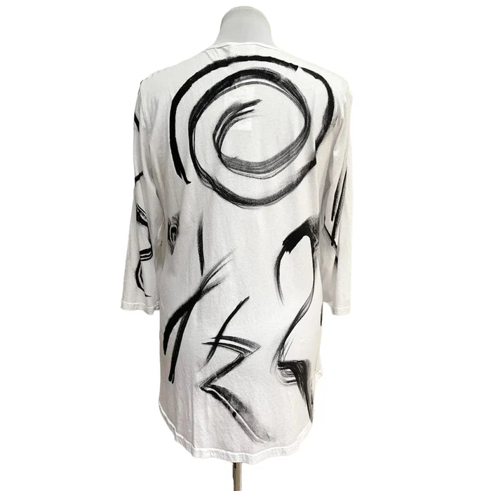 Mannequin wearing a white garment with black abstract patterns on a white background