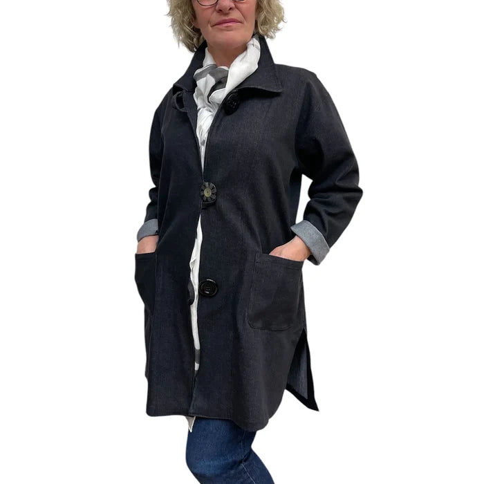 Person wearing a dark blue coat with a white background
