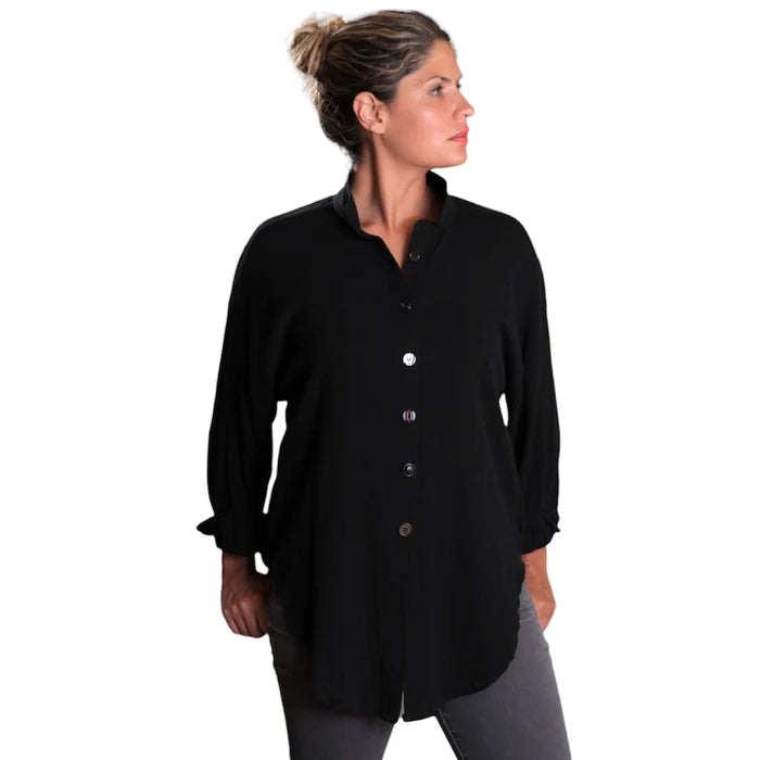 Woman wearing a black button-up shirt on a white background