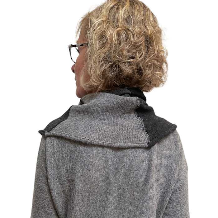 Person wearing a gray coat with a black collar on a white background