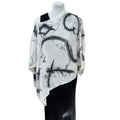 Mannequin wearing a black and white abstract patterned top on a white background