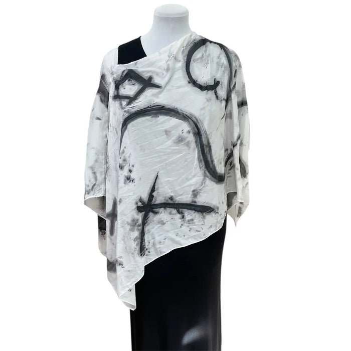Mannequin wearing a black and white abstract patterned top on a white background