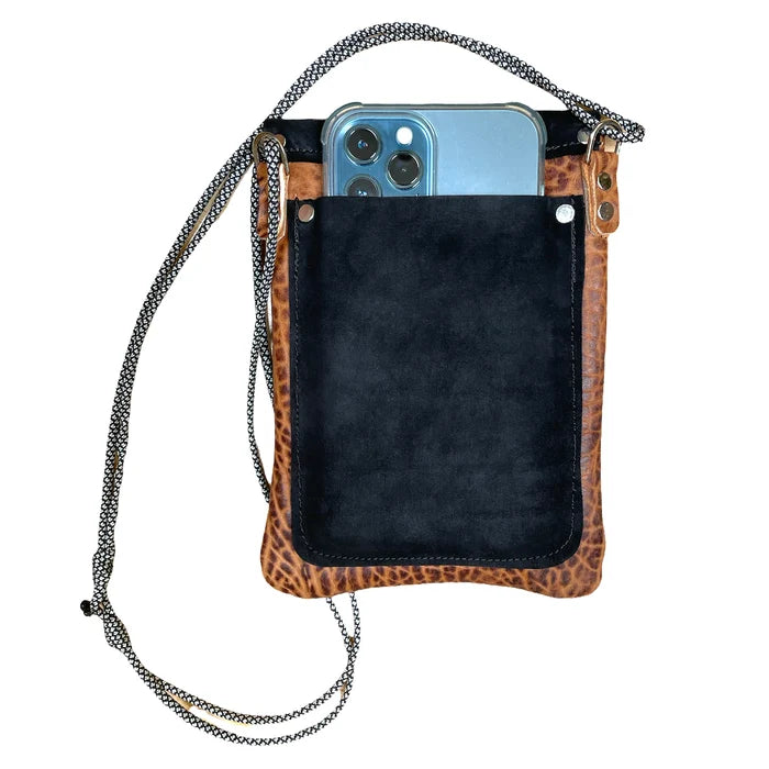 Phone case with leopard print edge and black interior, held by a chain strap.