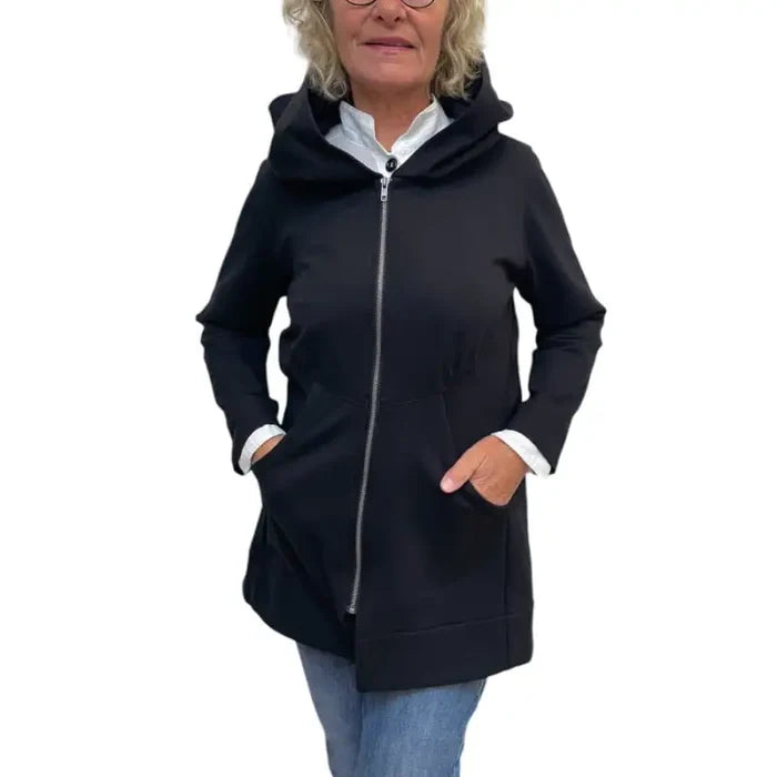 Person wearing a black zip-up hoodie on a white background