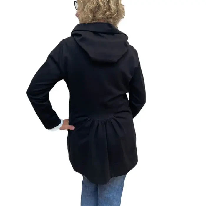 Person wearing a black coat with a hood on a white background