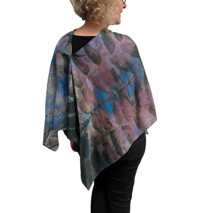 Person wearing a colorful scarf with abstract patterns on a white background