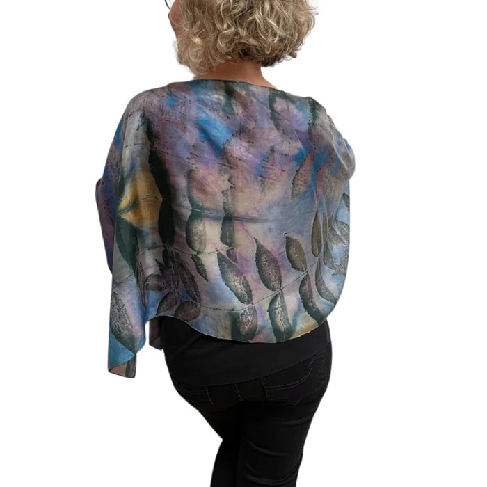 Person wearing a colorful abstract patterned top on a white background