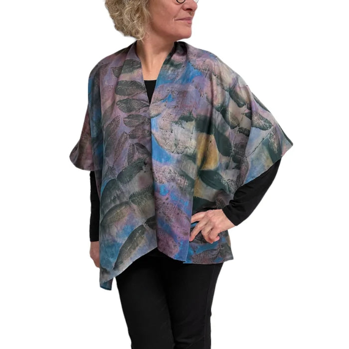 Woman wearing a colorful patterned scarf on a white background