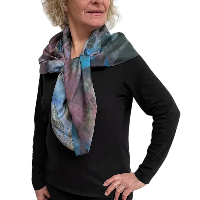 Woman wearing a colorful scarf on a white background