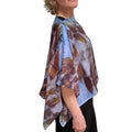 Person wearing a floral patterned scarf on a white background