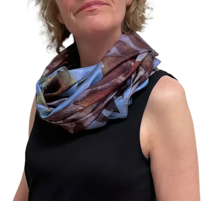 Woman wearing a colorful scarf on a white background