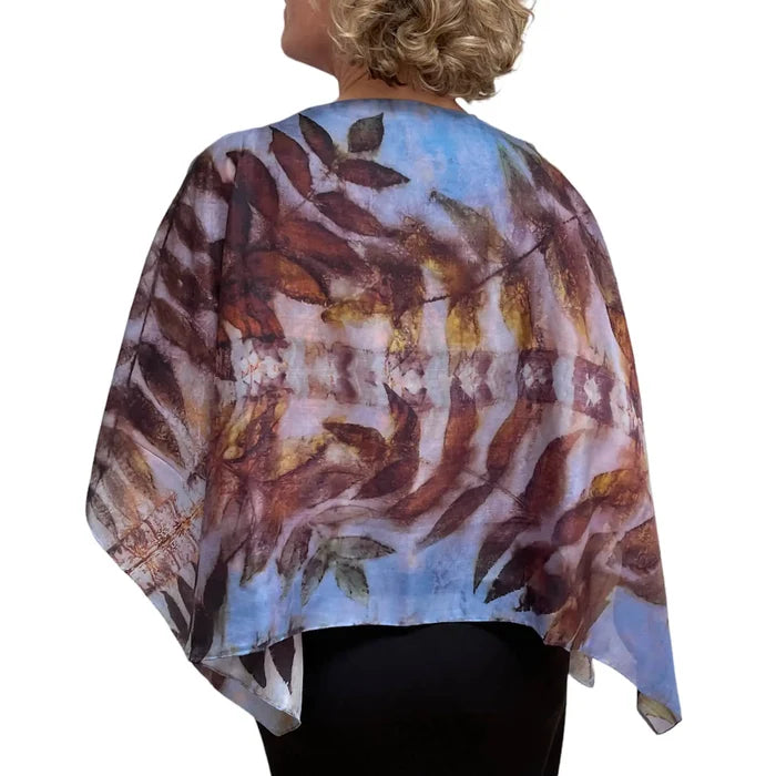 Woman wearing a floral patterned scarf on a white background