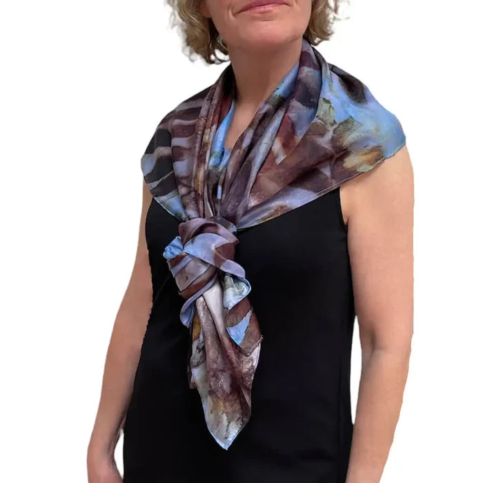Woman wearing a colorful scarf on a white background
