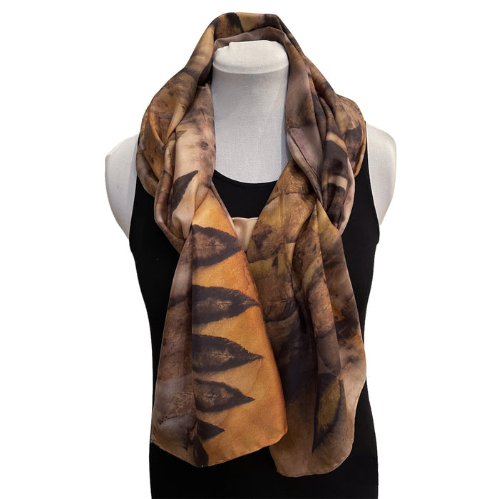 Patterned scarf on a mannequin against a white background