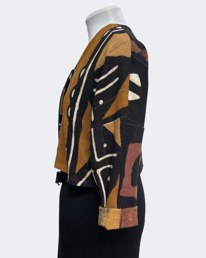 Mannequin wearing a patterned jacket with abstract design on a white background