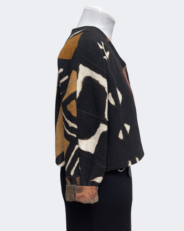 Sweater with abstract pattern on a mannequin against a white background