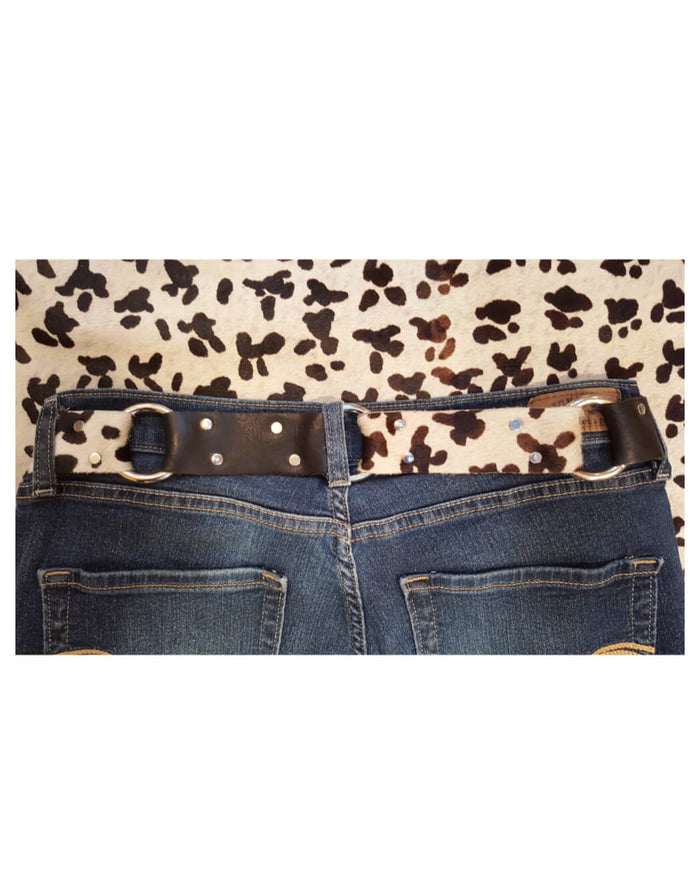 Leopard print belt with a polka dot buckle on a white background
