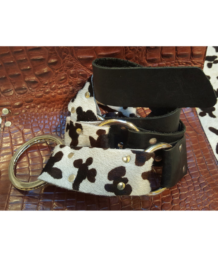 Belt with cow print strap on a textured surface