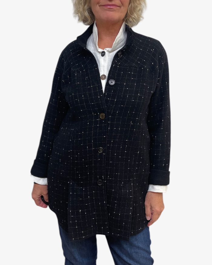 Person wearing a dark blue checkered coat on a white background