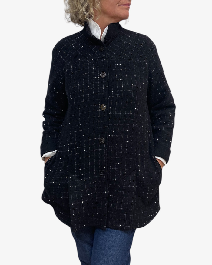 Person wearing a dark blue checkered coat on a white background
