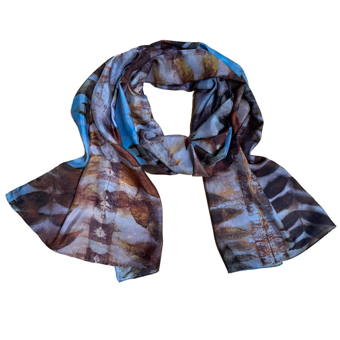Patterned scarf with brown, blue, and beige colors on a white background