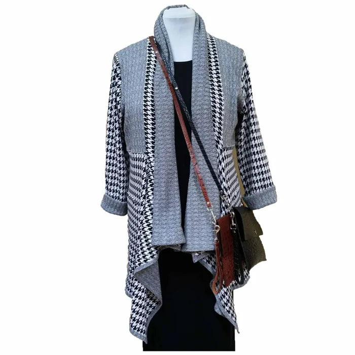 Mannequin wearing a gray and black houndstooth patterned cardigan with a brown leather bag.