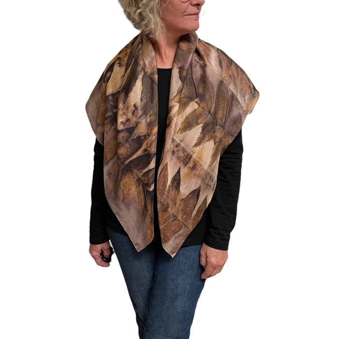 Woman wearing a patterned scarf on a white background