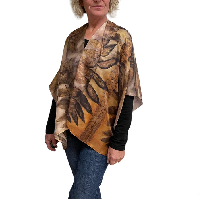 Person wearing a patterned scarf on a white background