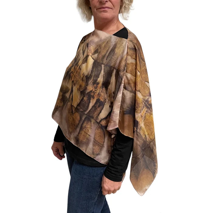 Person wearing a brown and beige patterned scarf on a white background