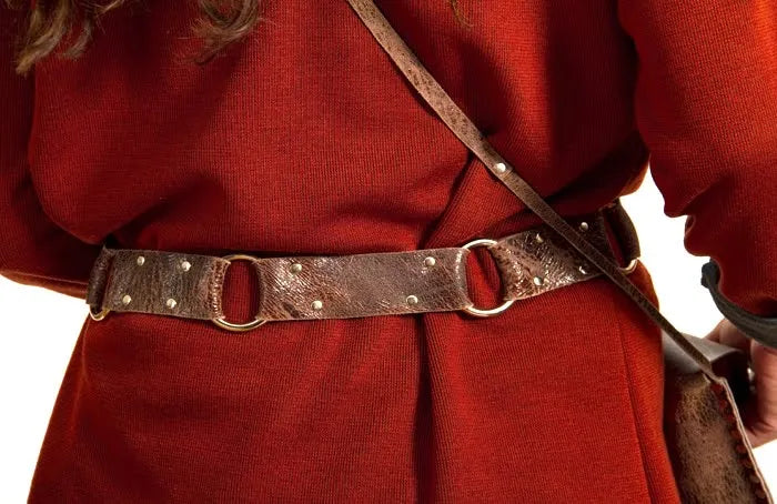 Person wearing a red garment with a brown belt and shoulder strap on a white background
