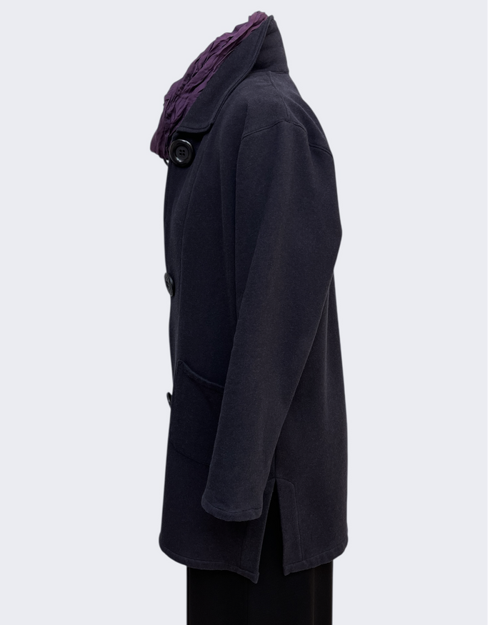 Dark coat with a purple hood on a light gray background
