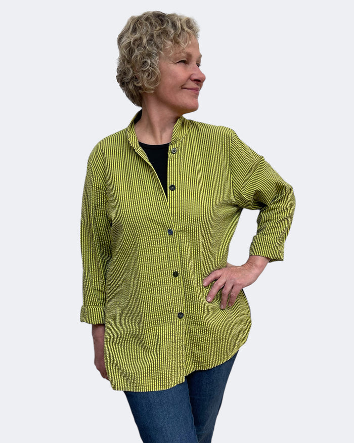 Woman wearing a green checkered shirt against a white background