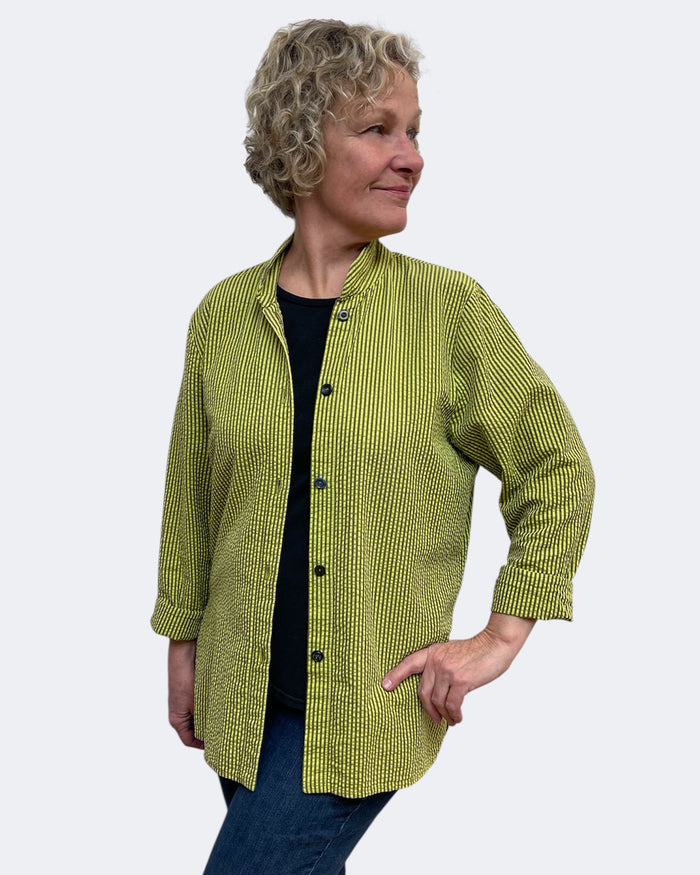 Woman wearing a green checkered shirt against a white background