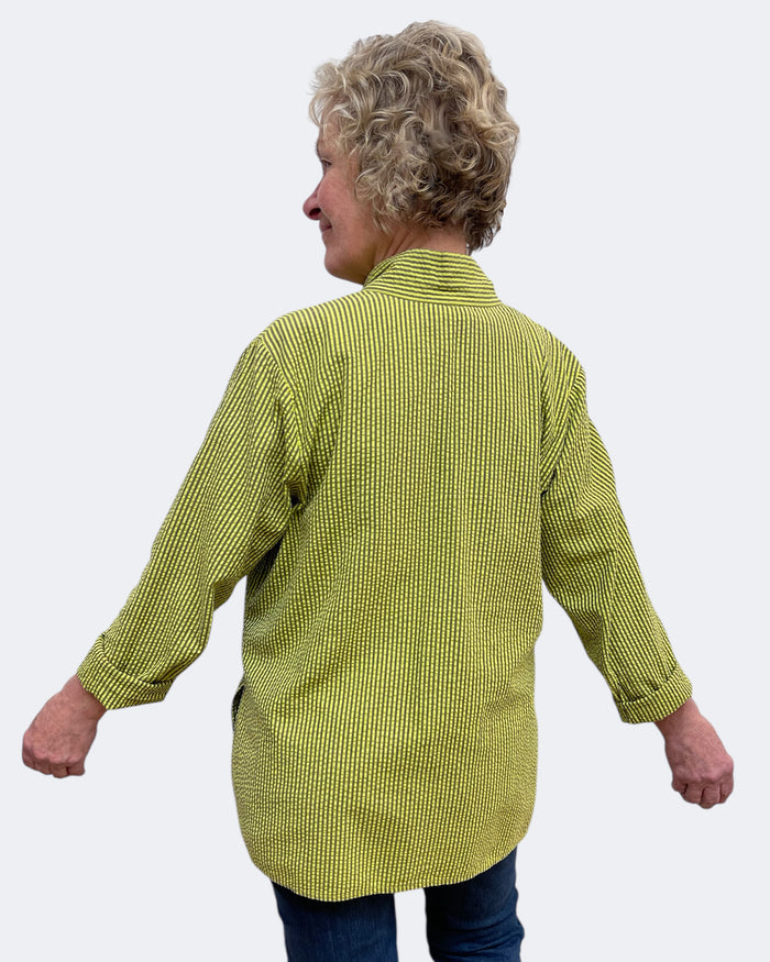Person wearing a green checkered shirt against a white background