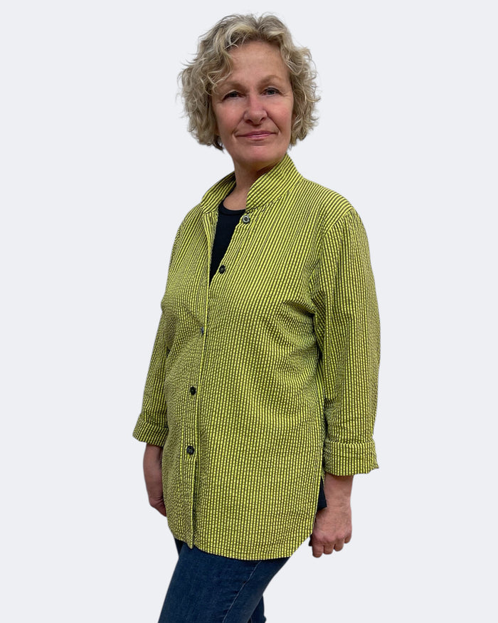 Person wearing a green checkered shirt against a white background