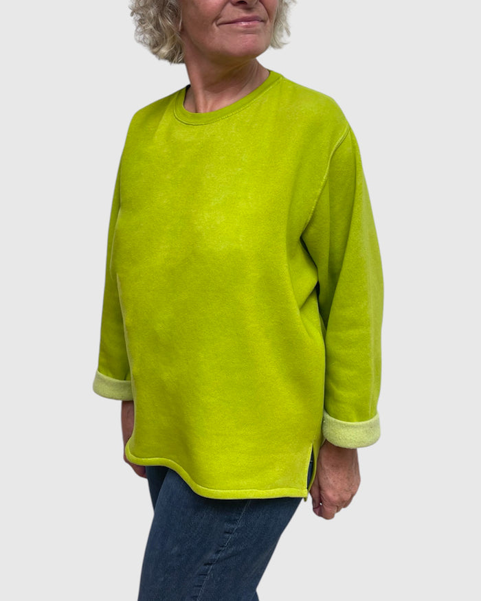 Close up of side slit on chartreuse hand dyed sweatshirt tunic