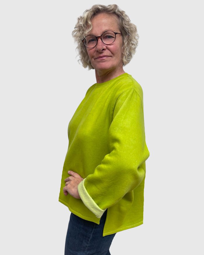 Close up two of side slit on chartreuse hand dyed sweatshirt tunic