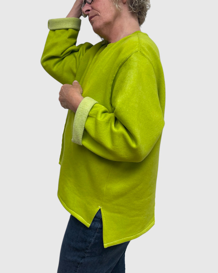 Close up three of side slit on chartreuse hand dyed sweatshirt tunic