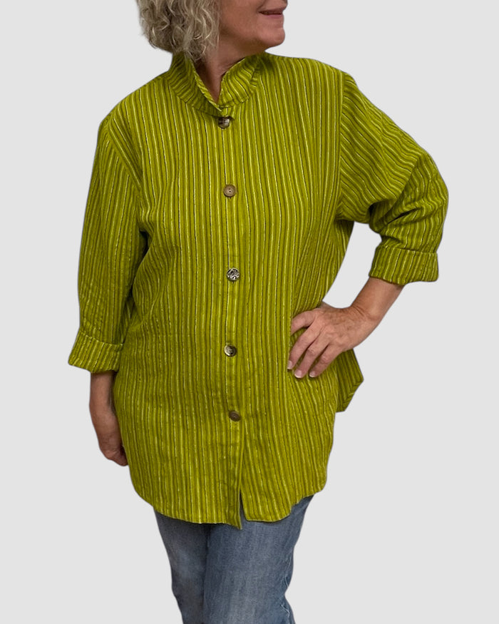 Person wearing a green textured jacket on a plain background