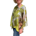 Woman wearing a leaf-patterned scarf on a white background