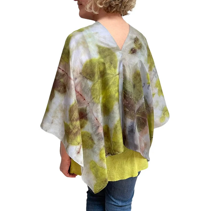 Woman wearing a floral kimono-style garment with a white background