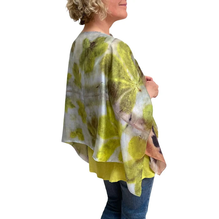 Woman wearing a colorful kimono-style garment with abstract patterns on a white background