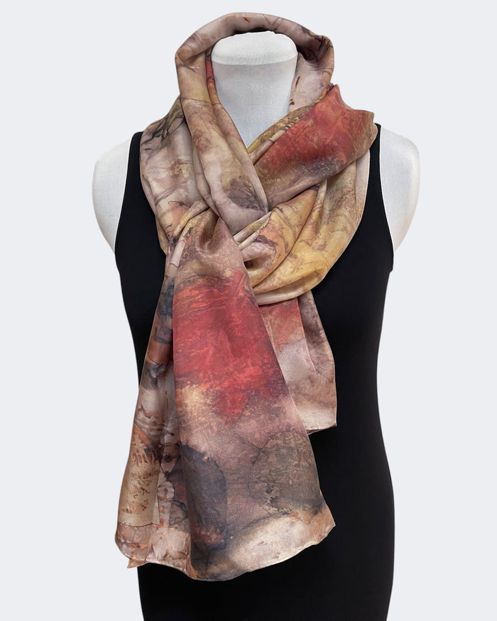 Mannequin wearing a colorful scarf with a neutral background