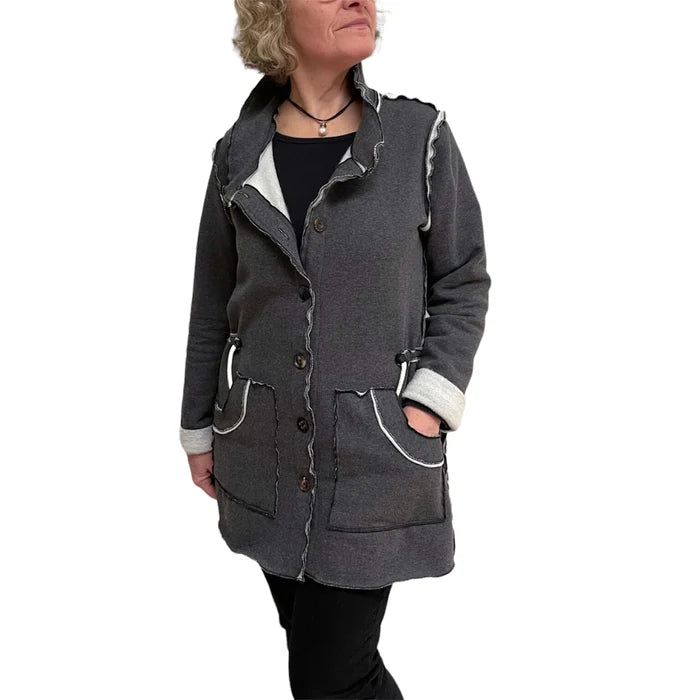 Person wearing a gray coat with white lining on a white background